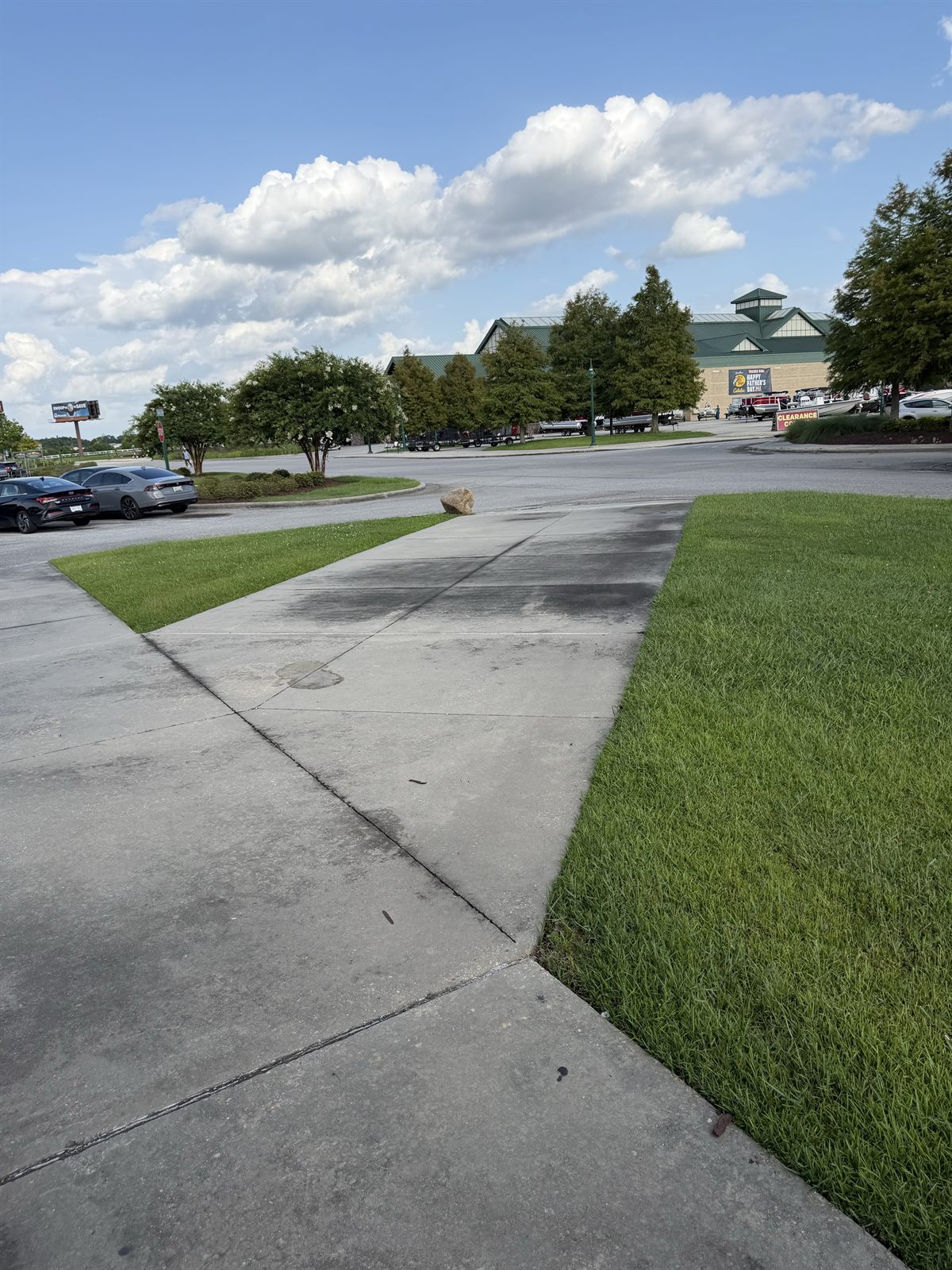 Commercial concrete walkway before pressure washing with dark surface buildup
