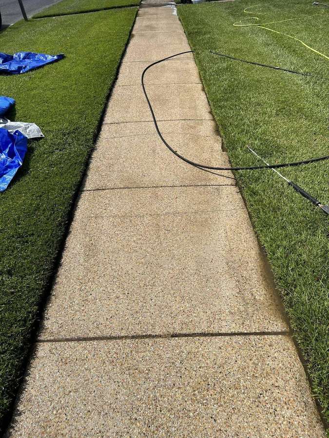 Concrete sidewalk after pressure washing